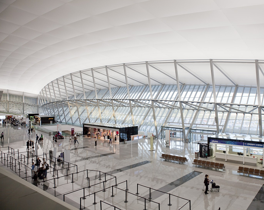 Carrasco Airports interior showcases its curved roof and ERCO lighting, enhancing the airy terminal.