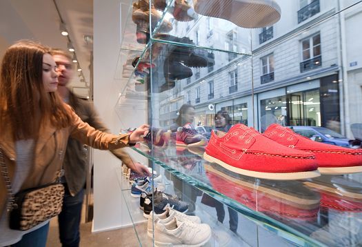 Customers view shoes in the Colette store, Paris, illuminated by ERCO LED lighting.