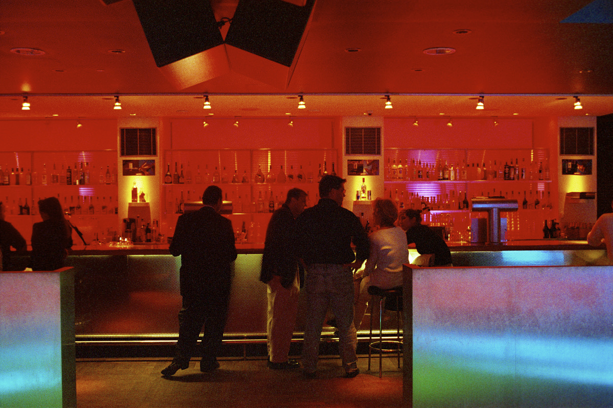 Red color effect in a bar, creating a warm, energetic atmosphere with ERCO lighting.