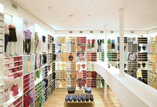 Interior of a Uniqlo clothing store, showcasing colorful merchandise and lighting.