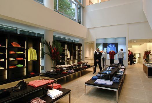 Clothing store showcasing merchandise, highlighting color rendition through lighting.