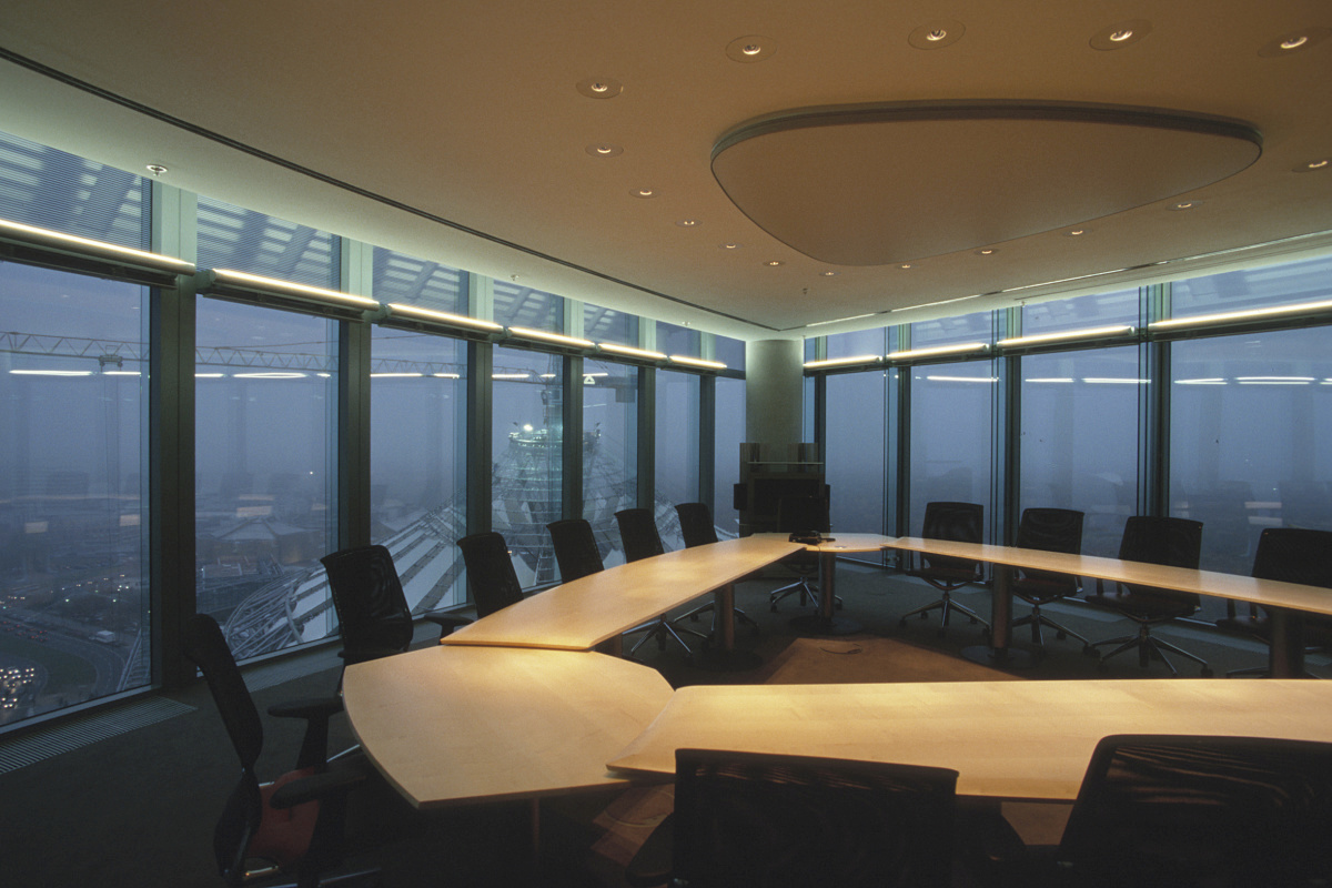 Conference room featuring ERCO lighting with a nighttime city view.