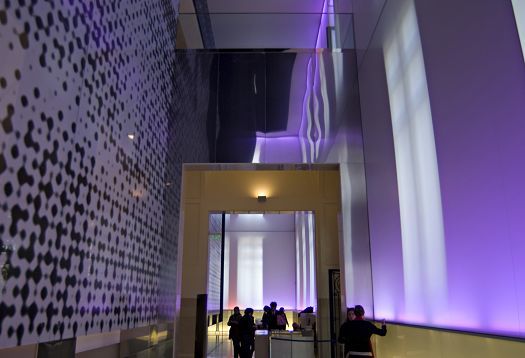 Architectural interior featuring colored ERCO lighting design and pedestrian traffic.