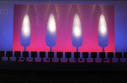 ERCO lighting design featuring colored light effects and tree motifs for atmospheric illumination.