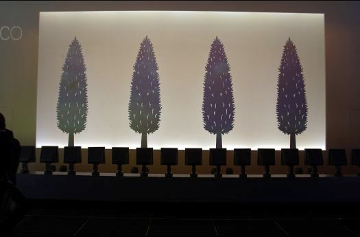 ERCO lighting installation featuring tree motifs and colored illumination for atmospheric light effects.