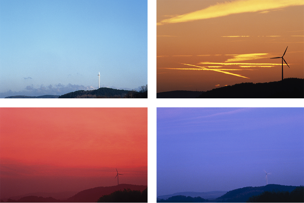Wind turbines under varied lighting, demonstrating color constancy.