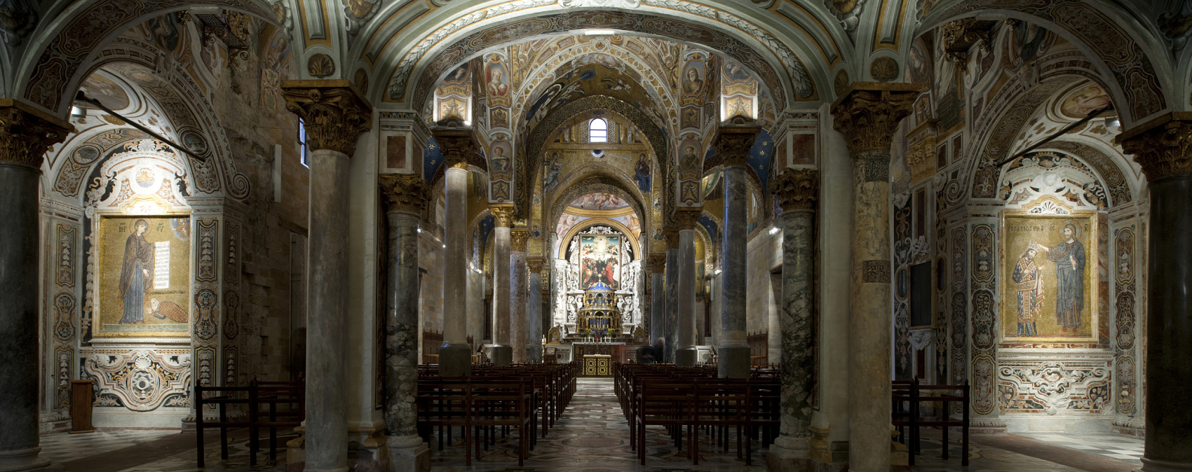 Church interior featuring columns and mosaics, illuminated with ERCO lighting for a contemplative atmosphere.