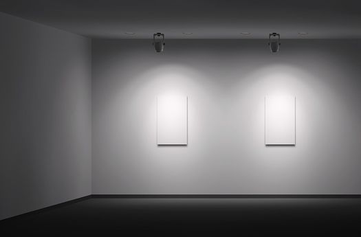 Gallery space featuring ERCO spotlights creating contrast on white canvases.