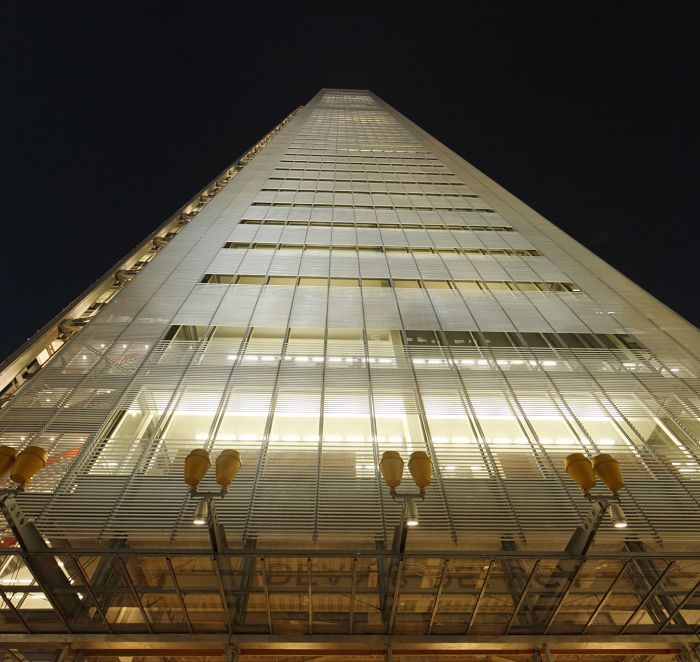 Facade lighting of The Shard office building in London at night.