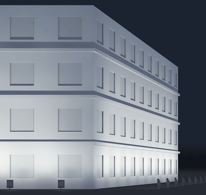 Facade lighting of a modern office building using ERCO light projectors.