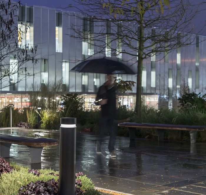 ERCO bollard luminaire provides glare-free path lighting in an outdoor setting.