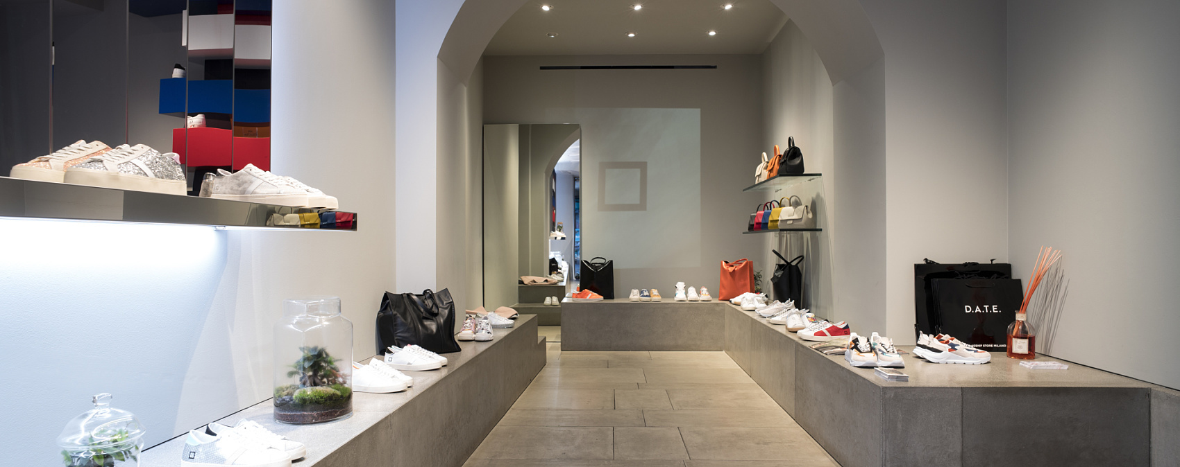 D.A.T.E. sneaker store in Milan featuring ERCO lighting for flexible product display.