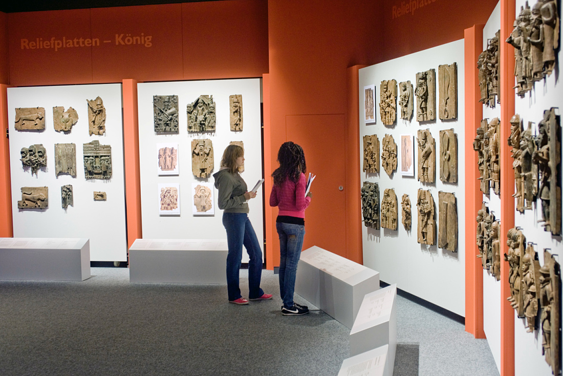 Visitors view African art at the Dahlem Ethnological Museum, illuminated by ERCO Optec LED spotlights.