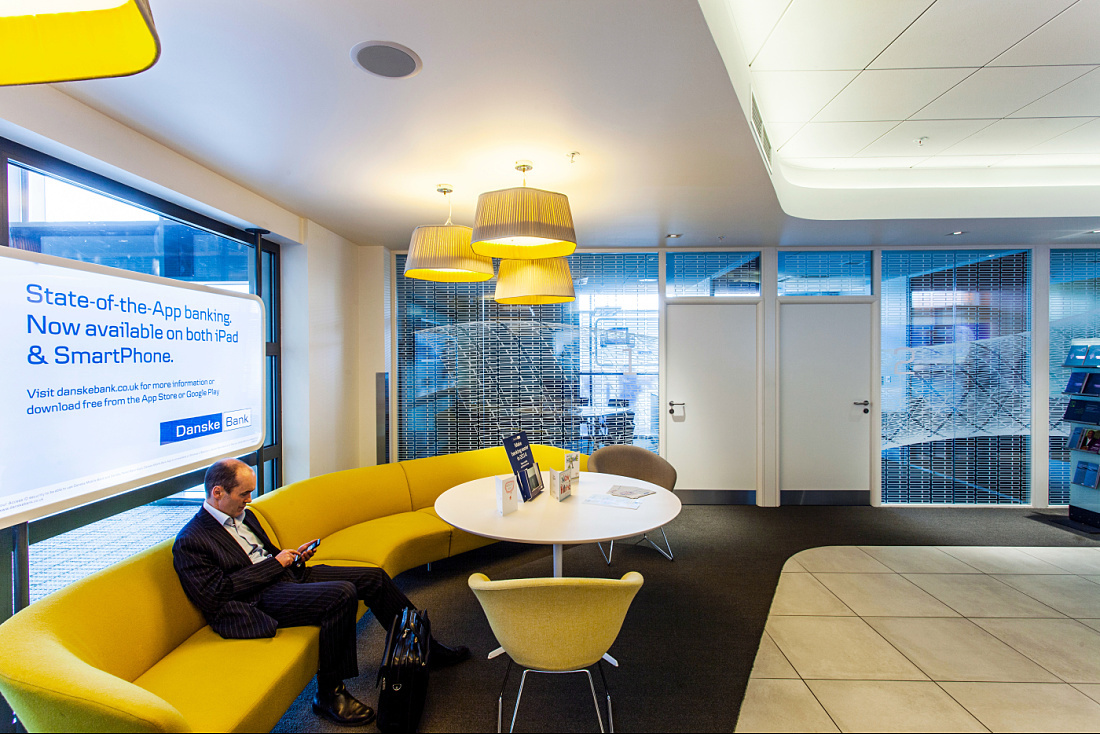 Danske Bank Belfast branch: Inviting waiting area with LED lighting and app advertisement.