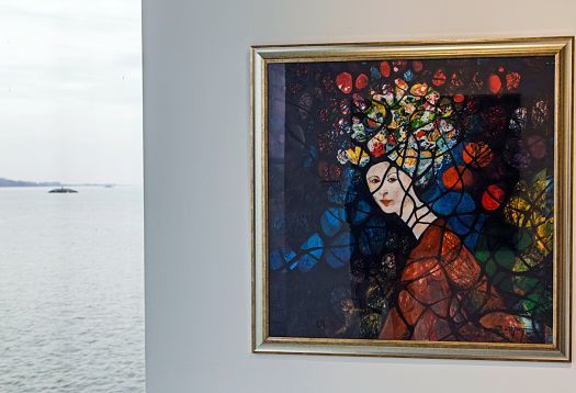 Artwork at Danubiana Museum: Woman with colorful headdress, illuminated by ERCO lighting.