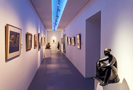 Danubiana Museum interior featuring sculptures and paintings, illuminated by ERCO lighting.