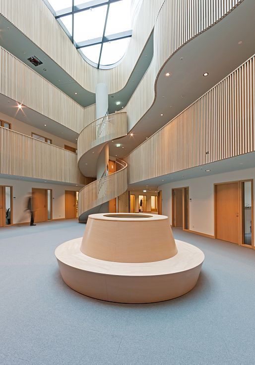 Interior of the Department of Urban Development and Environment, Hamburg, featuring a spiral staircase and ERCO lighting.