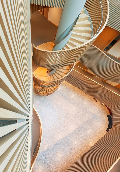Spiral staircase in Hamburgs Department of Urban Development, featuring ERCO lighting.
