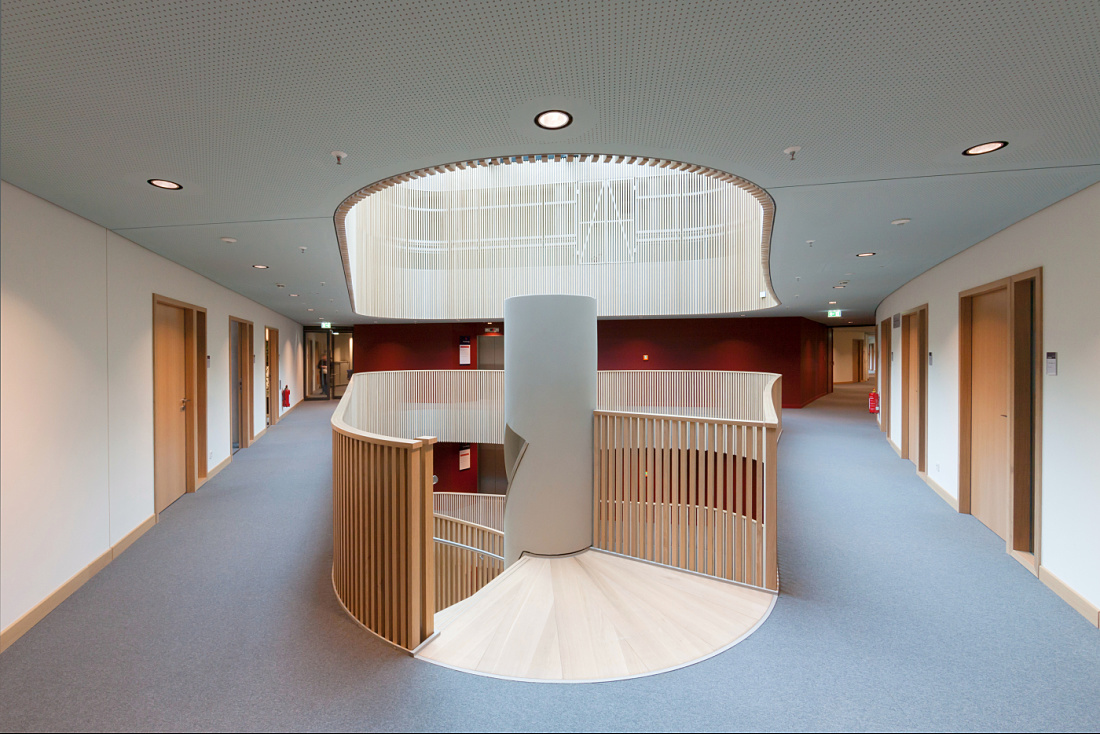 Interior of the Department of Urban Development and Environment in Hamburg, featuring a staircase and ERCO lighting.