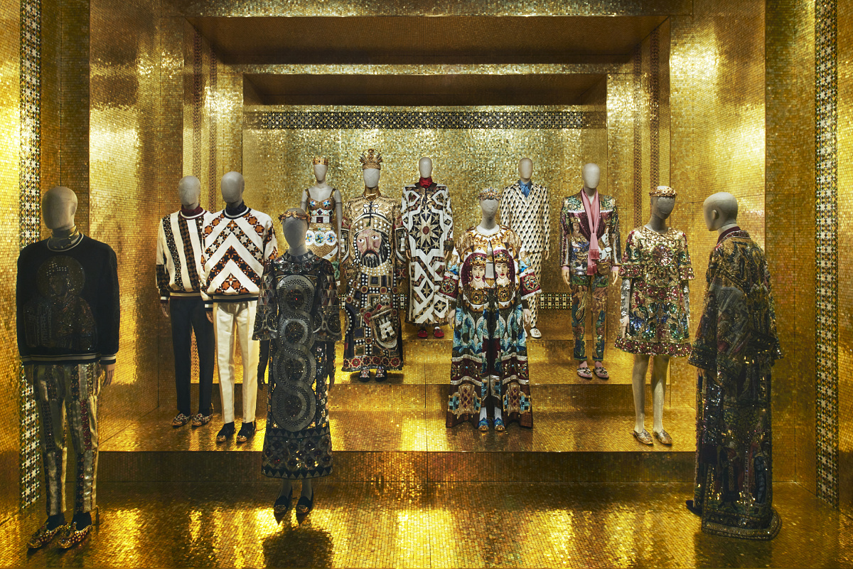 Dolce & Gabbana exhibit in Milan, illuminated by ERCO LED spotlights, highlighting fashion art.