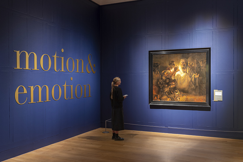 Visitor views Rembrandt's painting at Dulwich Picture Gallery, illuminated by ERCO LED spotlights.