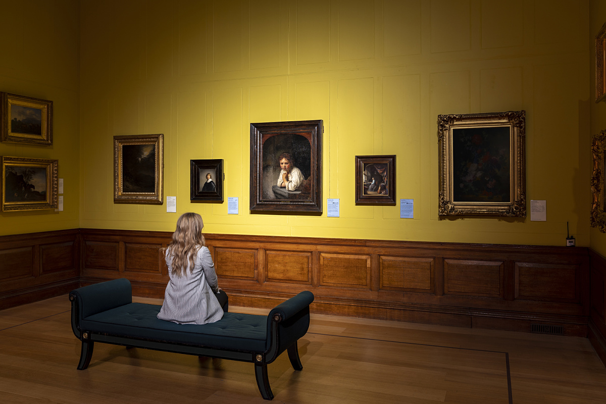 Visitor views Rembrandt's paintings illuminated by ERCO LEDs at Dulwich Picture Gallery.