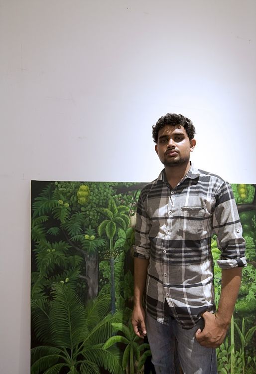 Man stands before art at Durbar Hall, Kochi Biennale, illuminated by ERCO Logotec LED spotlights.