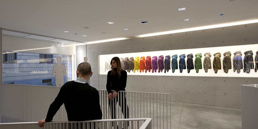 Duvetica showroom featuring ERCO LED lighting and a display of down jackets in Milan.