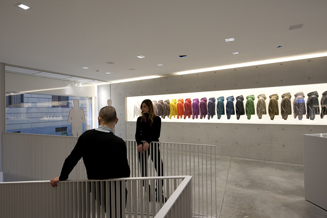 Duvetica showroom featuring ERCO LED lighting and colorful down jackets.