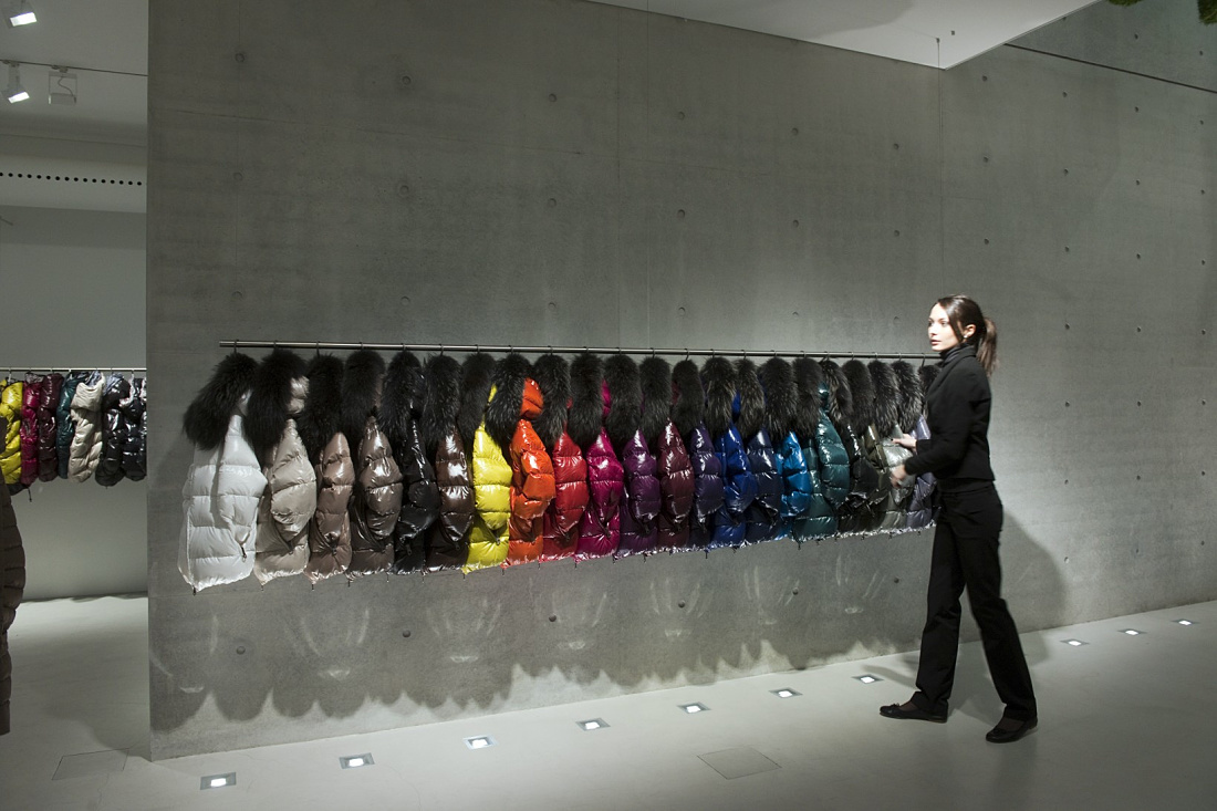 Duvetica down jackets in a showroom, illuminated by ERCO LED lighting.
