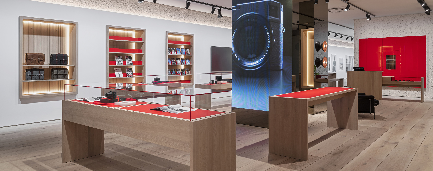 Leica Store Munich: ERCO lighting showcases cameras and art with Eclipse spotlights on tracks.