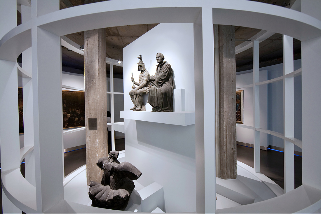 Exhibition space in Deutscher Dom, Berlin, featuring sculptures on German democracy, illuminated by ERCO lighting.