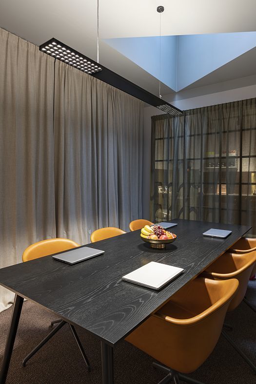 ERCO Jilly downlights illuminate a conference table in a modern Fabege office in Stockholm.