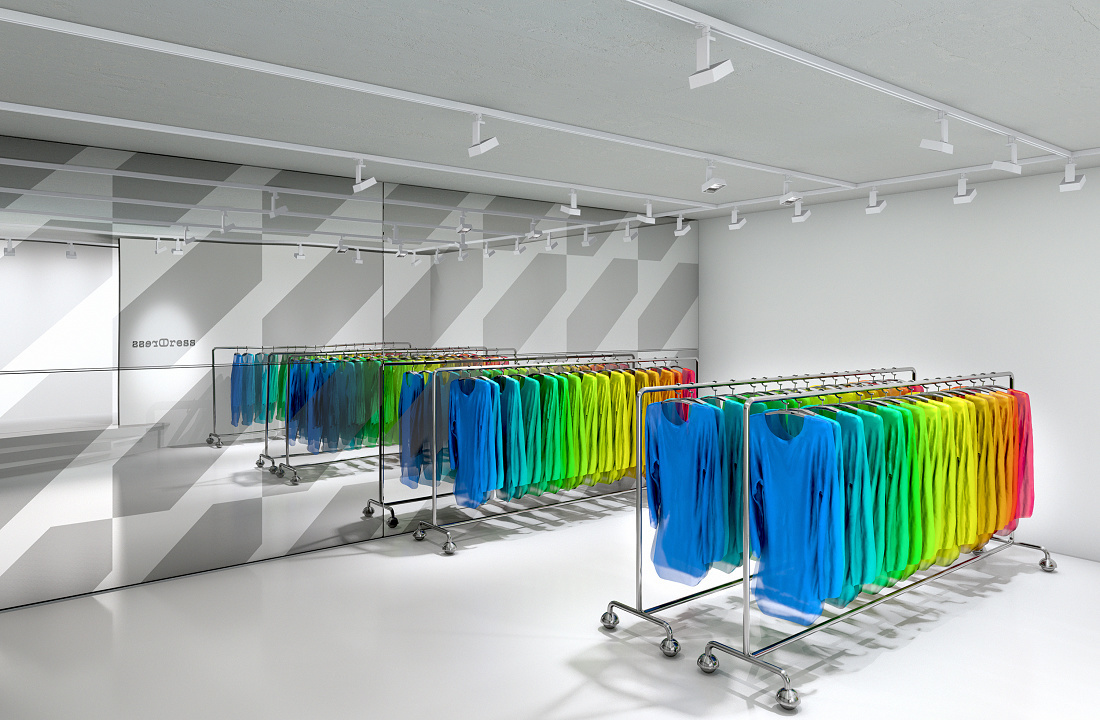 Illuminated clothing racks with colorful apparel in a fashion store, accented by ERCO lighting.