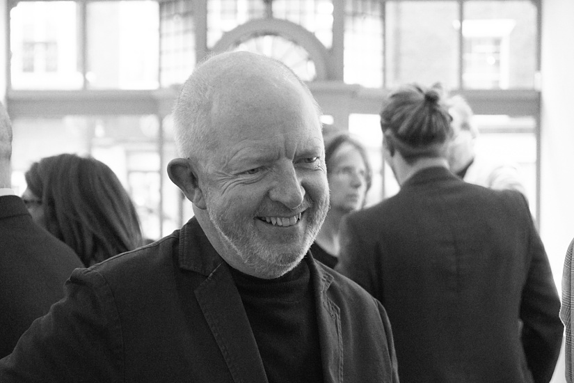 Man smiling at the ERCO London showroom film screening of Frank Lloyd Wright documentary.