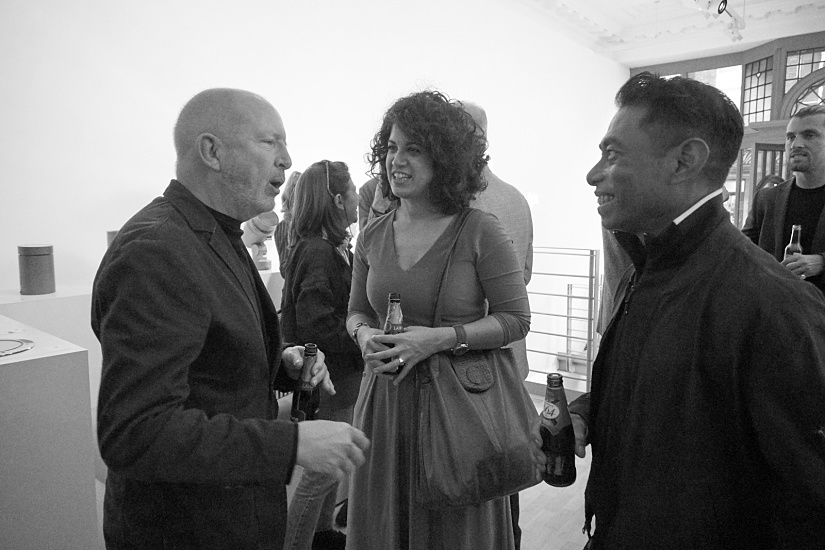 Attendees conversing at the ERCO London showroom during the Frank Lloyd Wright film screening.