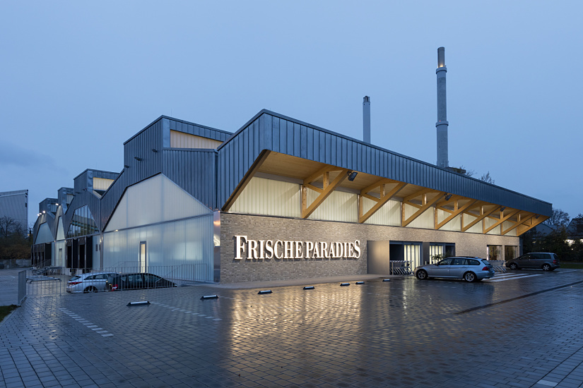 FrischeParadies Stuttgart store featuring ERCO LED spotlights for gourmet food presentation.