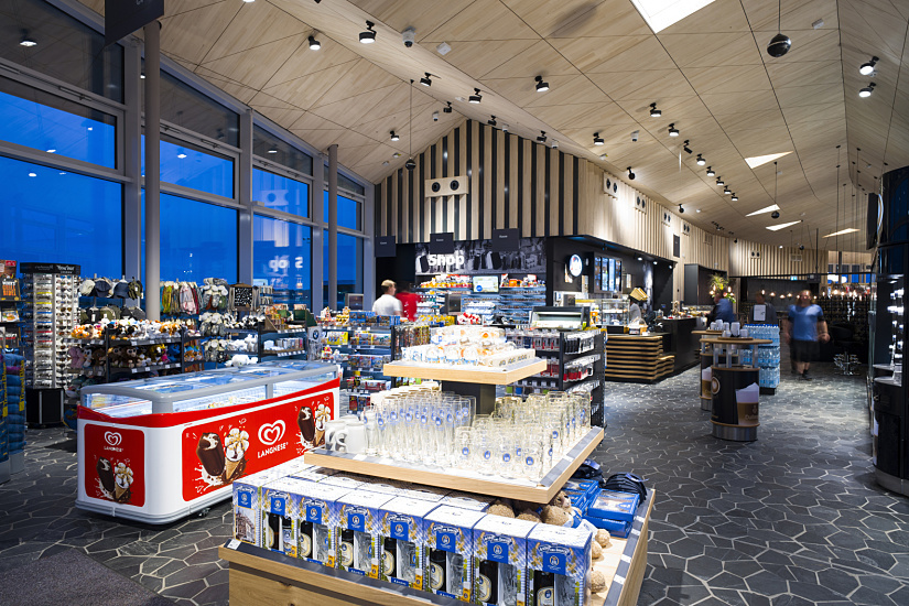 Interior of Fürholzen petrol station shop, showcasing ERCO lighting and merchandise.