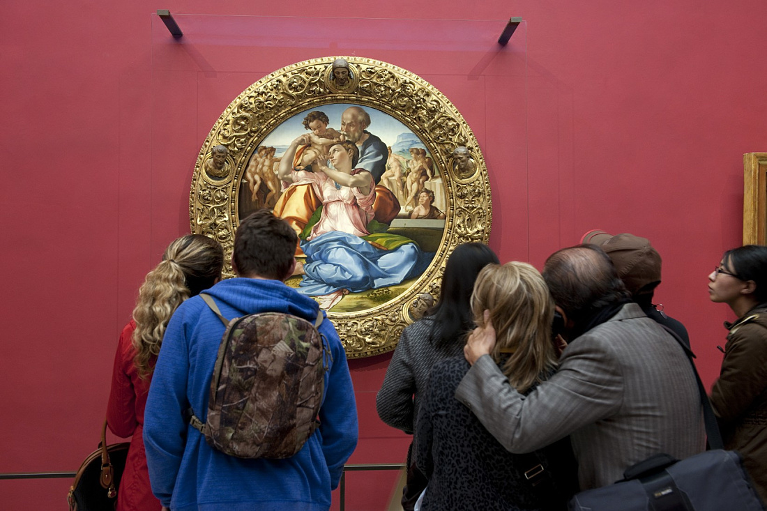 Visitors viewing a Raphael painting at the Uffizi Gallery, Florence.