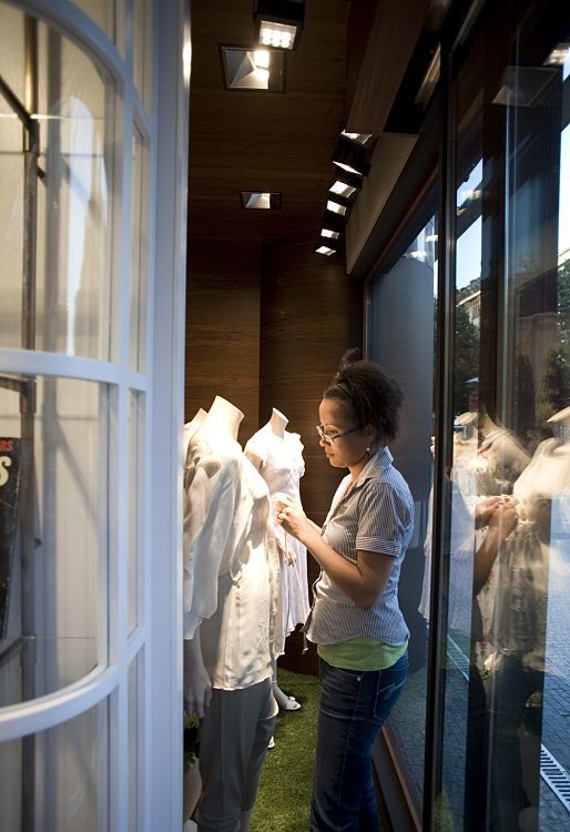 GANT flagship store in Prague lit by ERCO Logotec LED spotlights, accentuating window displays.
