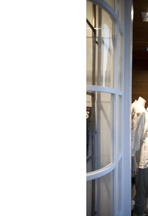 GANT flagship store in Prague lit by ERCO Logotec LED spotlights, accentuating window displays.
