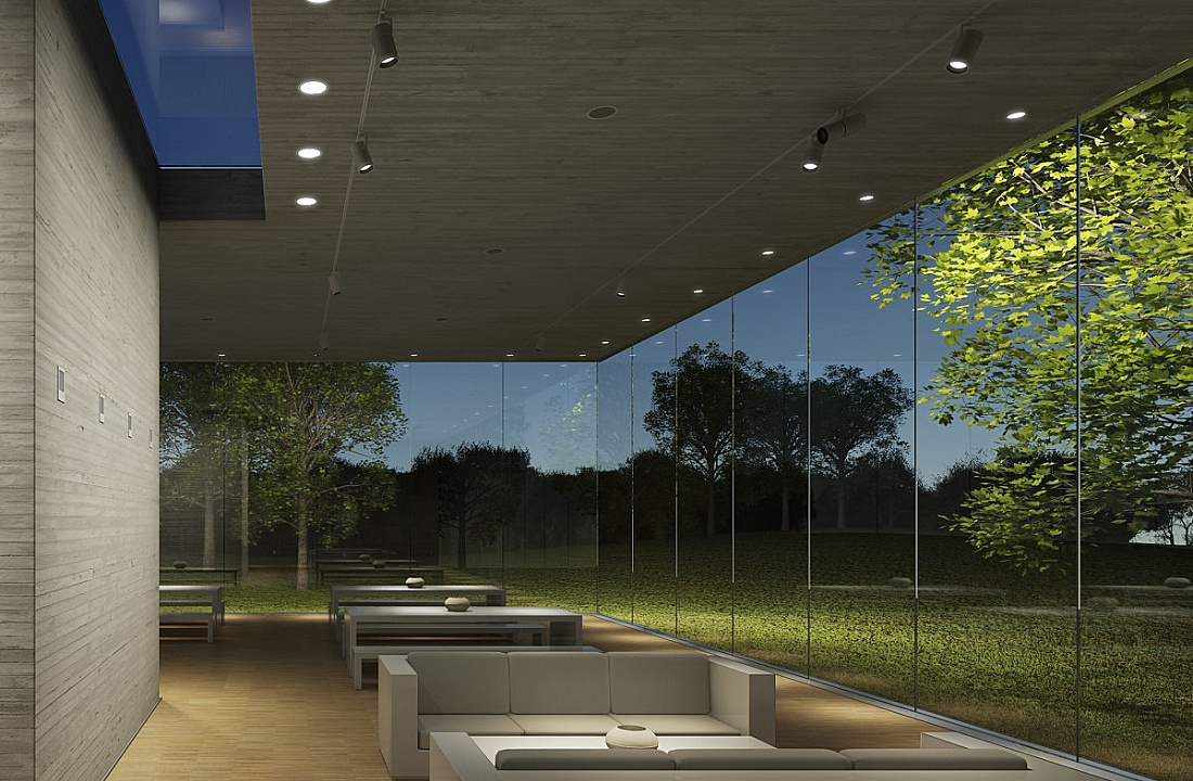Interior space with ERCO lighting and nature view through glass wall.