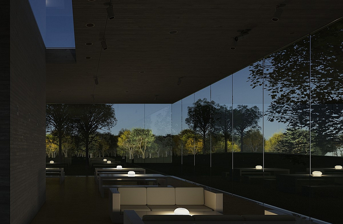 Interior with ERCO lighting and view of trees through glass wall, creating a tranquil atmosphere.