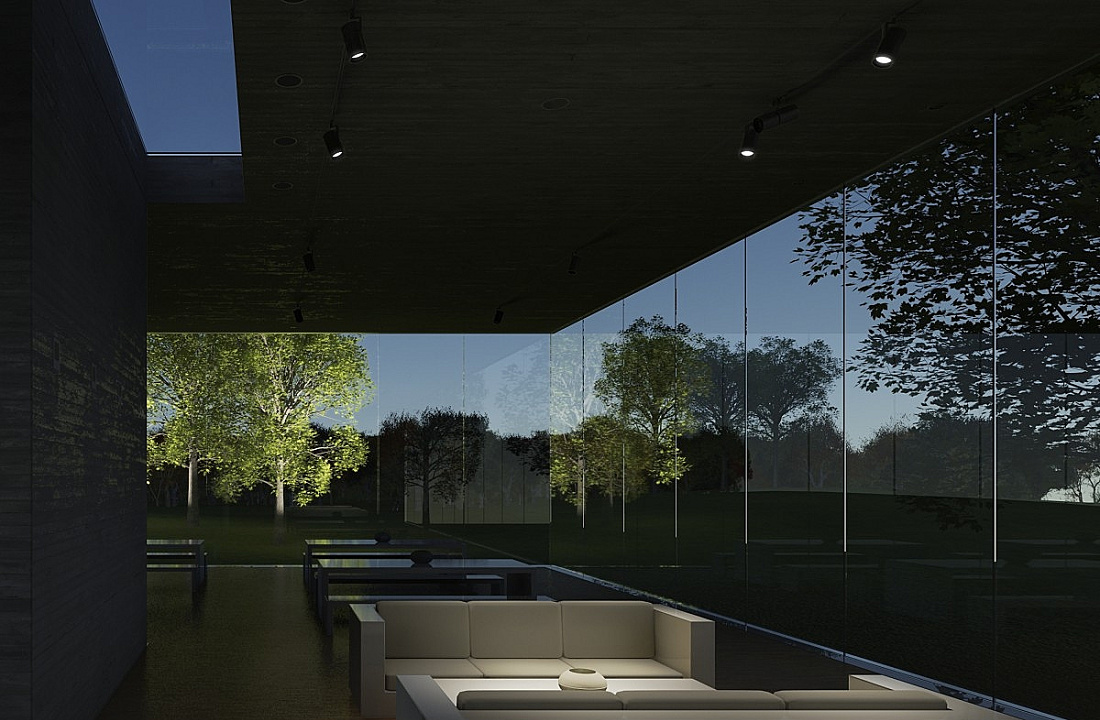 Interior with ERCO spotlights, offering a view through glass walls onto an illuminated garden landscape.