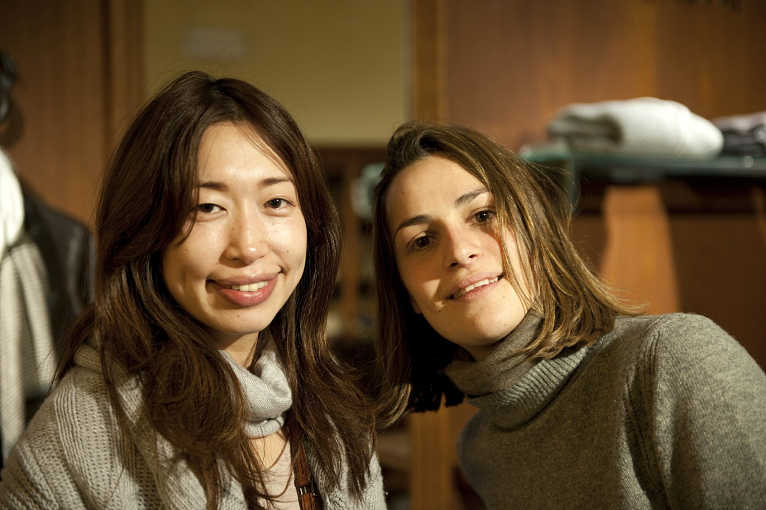Two women smile in the Genten shop, Florence, illuminated by ERCO LED lighting.