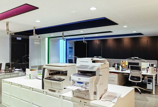 Graficas Varias office featuring ERCO LED lighting and ergonomic workstations.