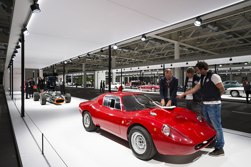 Red vintage car at the Grand Basel show, illuminated by ERCO spotlights.