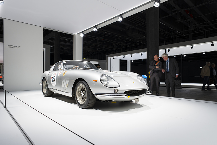 Silver vintage Ferrari showcased at Grand Basel, illuminated by ERCO spotlights.