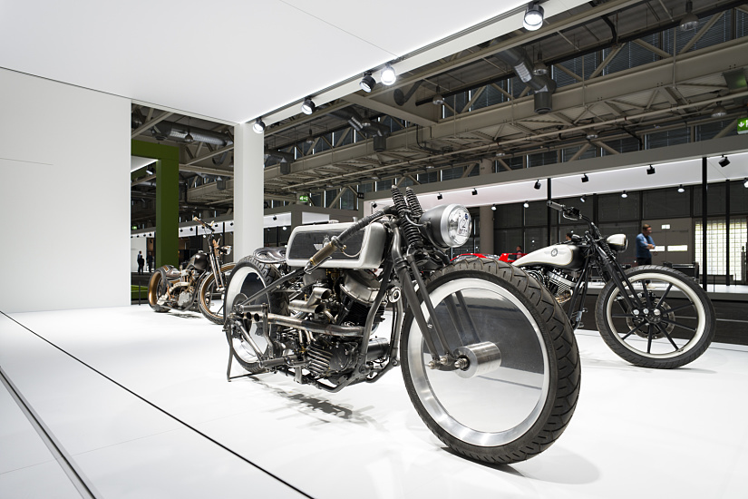 Classic motorcycles displayed under ERCO lighting at Grand Basel, highlighting the vehicles' aesthetics and collector value.