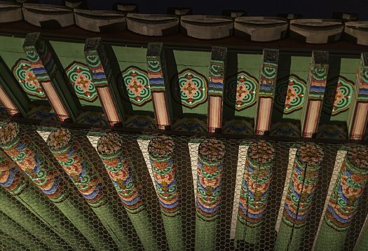 Detailed view of the Gyeongbokgung Palaces ornate roof structure, illuminated by ERCO lighting.
